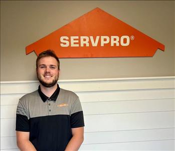 Young man standing in front of the SERVPRO sign.